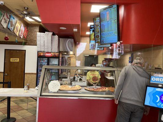 Counter with display of menu and pizzas