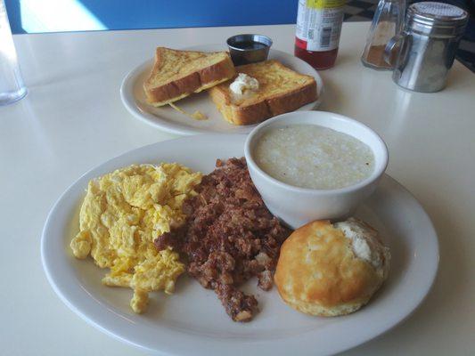 Breakfast Platter with corned beef hash grits and eggs and a biscuit. With a side order of french toast