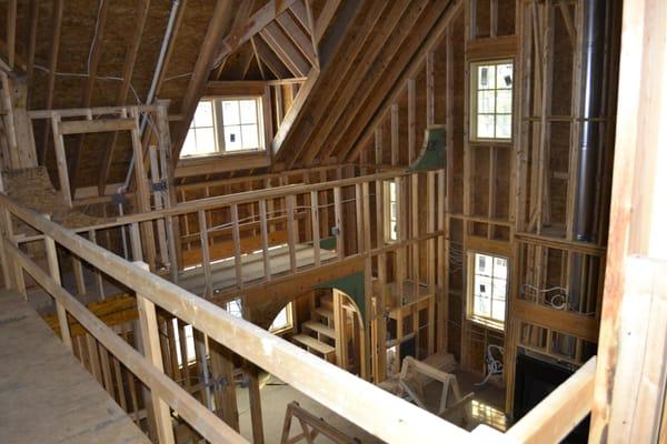 View from the upper level balcony looking down into the living room.