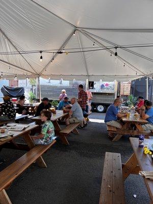 Outdoor dining and beer tent with food trucks