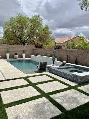 All American Landscape installed turf, potted and in ground plants, lighting, and river rock.