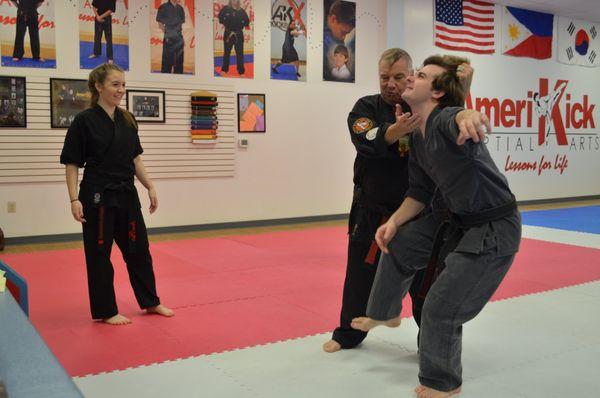 Grand master Dennis Tosten karate chopping sensei Brendan, owner of Amerikick West Linn