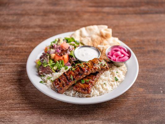 Adana Kebab Plate with basmati rice, house salad, pita bread slices, your choice of in-house made sauce and pickled red onions.