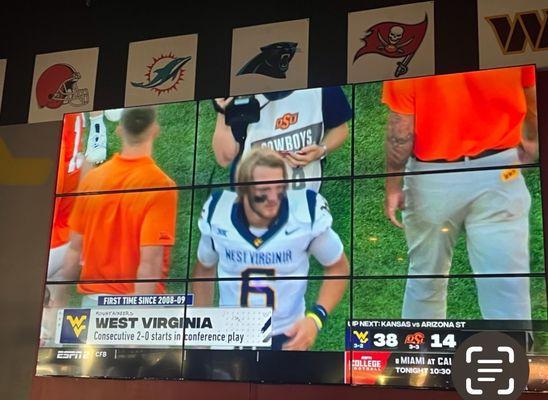 Giant Tv on the West wall, multiple TVs behind the bar and on the other side of the bar.