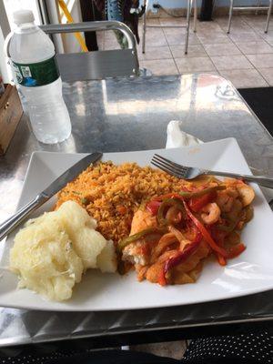 Pescado al vapor  fish with shrimps green and red bell peppers with tasty sauce comes with yellow rice and yucca!  Awesome!!