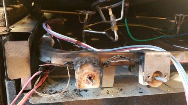 Do it yourselfer breaks burner tube. This is end result.  Small explosion and burnt spark switches and wires.