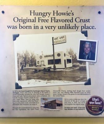 Plaque with the history of hungry Howie's Pizza on the wall