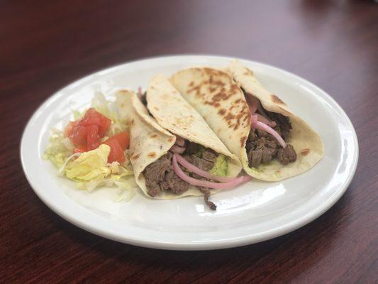 Tacos Al Carbon 

Seasoned beef fajita with guacamole and onions rolled in a homemade flour tortilla 

Served with a side salad