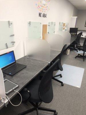 Setting up dividers in an office during Covid. We also put Ethernet ports at every station so users can connect without Wi-Fi.