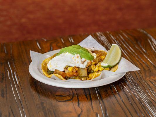 Spiced Crispy Potatoes with Grilled Corn, Poblano Peppers, Quesillo Cheese & Avocado Salsa Verde