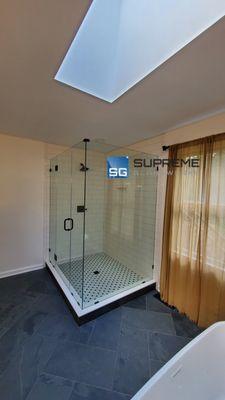 Total frameless clear glass shower door. Glass to glass door with matte black hardware finish