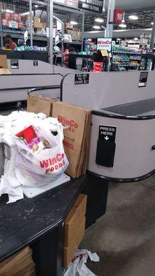 Conveyor belt right next to the Paper and plastic bags. This really helps w bagging groceries.