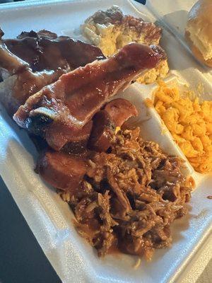 BBQ SAMPLE PLATTER PULLED PORK LINKS RIBS AND BRISKET WITH TWO SIDES OF BBQ SAUCE I GOT MAC N CHEESE AND POTATO SALAD