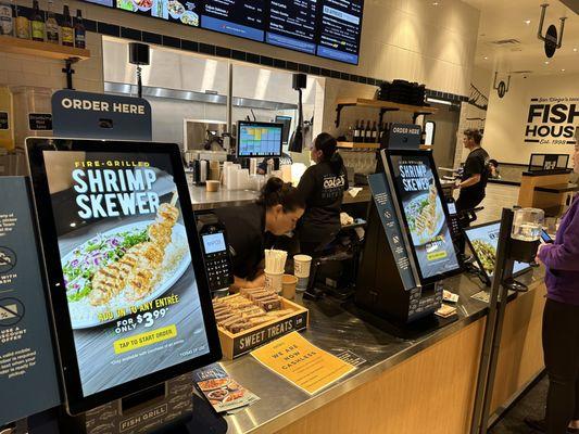 Ordering Stations - Two self serve kiosk and one staffed register - note they do NOT take cash.