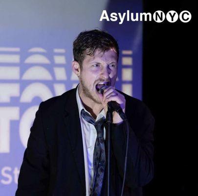 Zach Zucker preforming in his variety show 'Stamptown' at Asylum NYC.