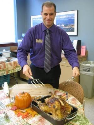 Our branch manager, Keith, preparing to carve a Thanksgiving turkey at our employee thanksgiving potluck!