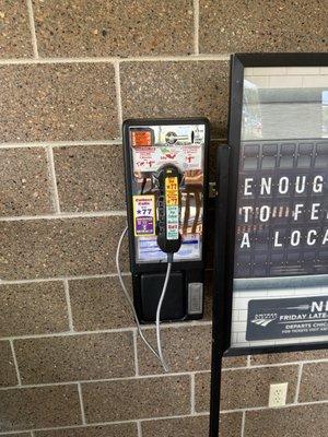 An actual pay phone with dial tone.