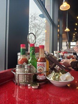 Condiments to be shared with your neighbor at the high counter