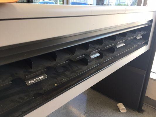 Empty mailing supply shelves filled with dust.