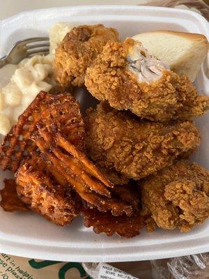 Combo meal with hot and spicy breaded chicken wings, Mac n cheese, sweet potato fries, and cornbread