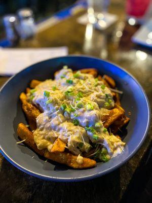 Crabby Fries: old bay seasoned french fries, asiago crab sauce, scallions