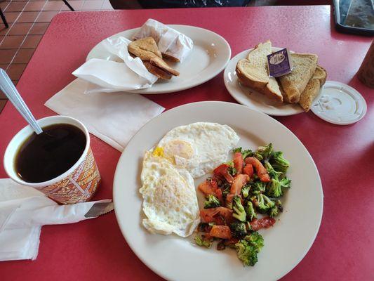 Coffee, grilled cheese, two eggs over medium with a side of grilled broccoli and tomatoes and a side of toast and jam.