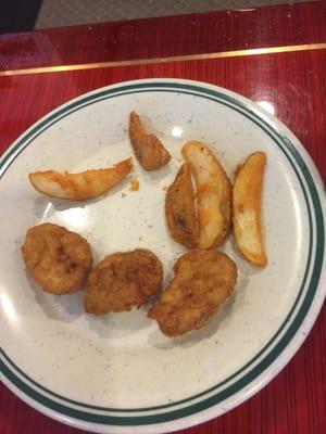 Here is some of the breaded card aid they call nuggets. The potatoes were cold rubber. As you can see the kids didn't touch it.