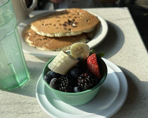 Two chocolate chip pancakes and cup of fruit