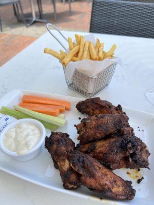 chicken wings with bleu cheese on the side and fries.