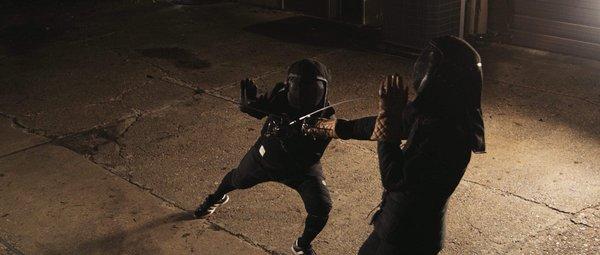 Fencer attacking an opponent during a bout.