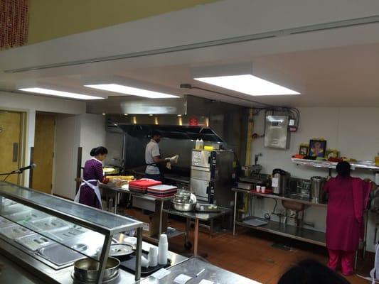 Open kitchen with the chef making dosa