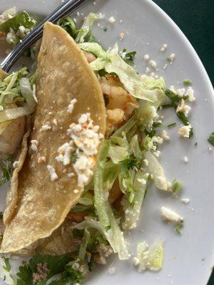 1/3 of my shrimp taco with a grilled corn tortilla.