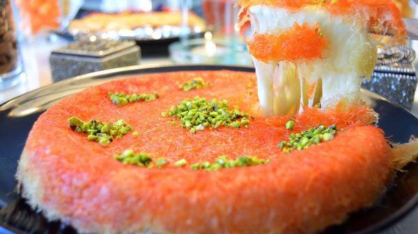 Our Signature Dessert.  Specialty cheese topped with fluffy dough covered with our syrup, and pistachios