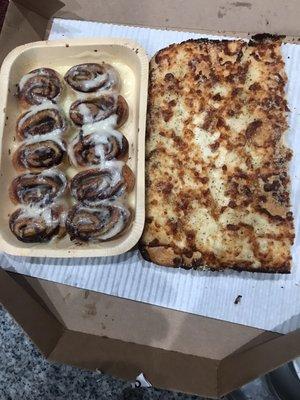 Cinnabon rolls and breadsticks with cheese topping