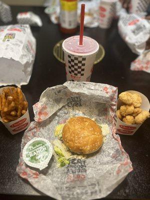 Checker burger, chicken bites, fries and drink