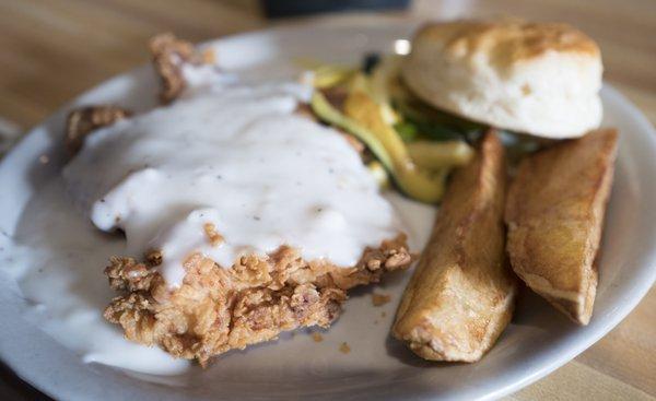 Chicken fried chicken with veggies and biscuit