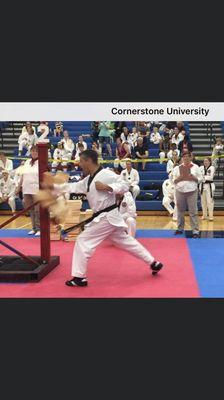 Master Willard breaking (6) 1" boards with a palm strike at Cornerstone University.