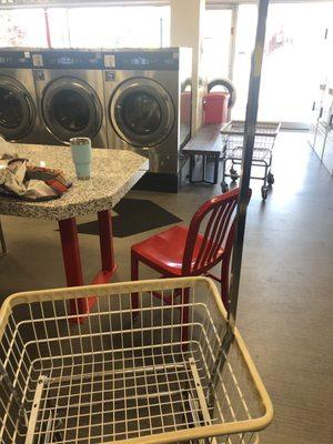 Red chairs for customers to sit in with tables for sorting.