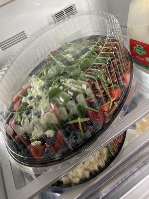 Large spinach salad with goat cheese, strawberries, blueberries , and pecans