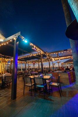 Outdoor patio is great after sunset, with live music every night. Heaters if you get cold. Don't forget that amazing view of the waterfront