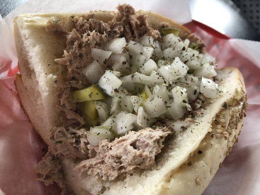 Tuna with onions and pickles on a hard roll