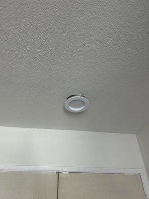 Our can light that was displaced during repiping with damage to the drywall all around it.