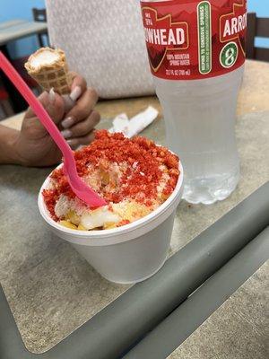 Elote  :Corn with Hot Cheetos served in a cup with Butter, Chile, Mayo and Cheese