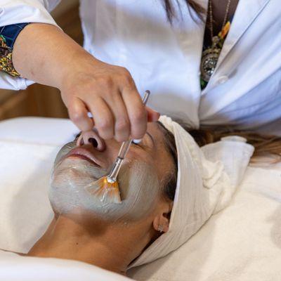 Brushing on SACRED CLAY for detoxification and brightening.