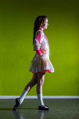 A champion Kelly Irish Dancer poses in her solo dress at the KSID Coventry Studio.