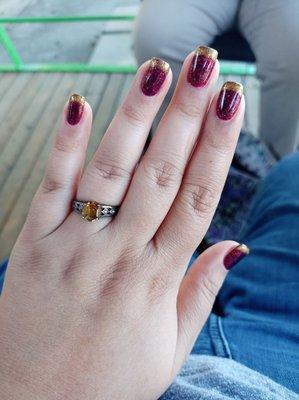 A deep sparkly red, with a glitzy gold tip