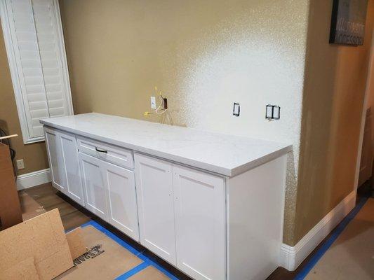 Beautiful granite countertop storage unit in adjacent den