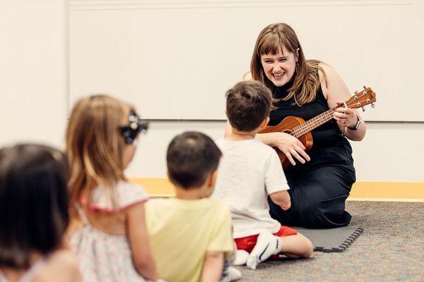 Students in one of Merit School of Music's Early Childhood classes sing along to the ukulele.