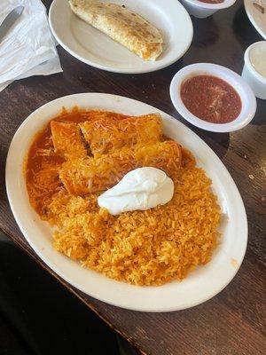 Chicken Enchiladas with rice and sour cream and a Cheese Quesadilla