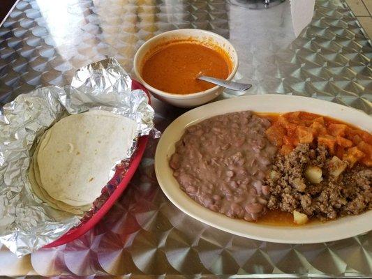 carne guisada with chicharrones in delicious refried beans with some of the most amazing salsa I've ever had in my life